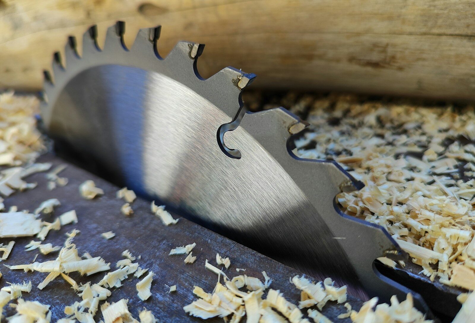 a close up of a metal blade on a piece of wood